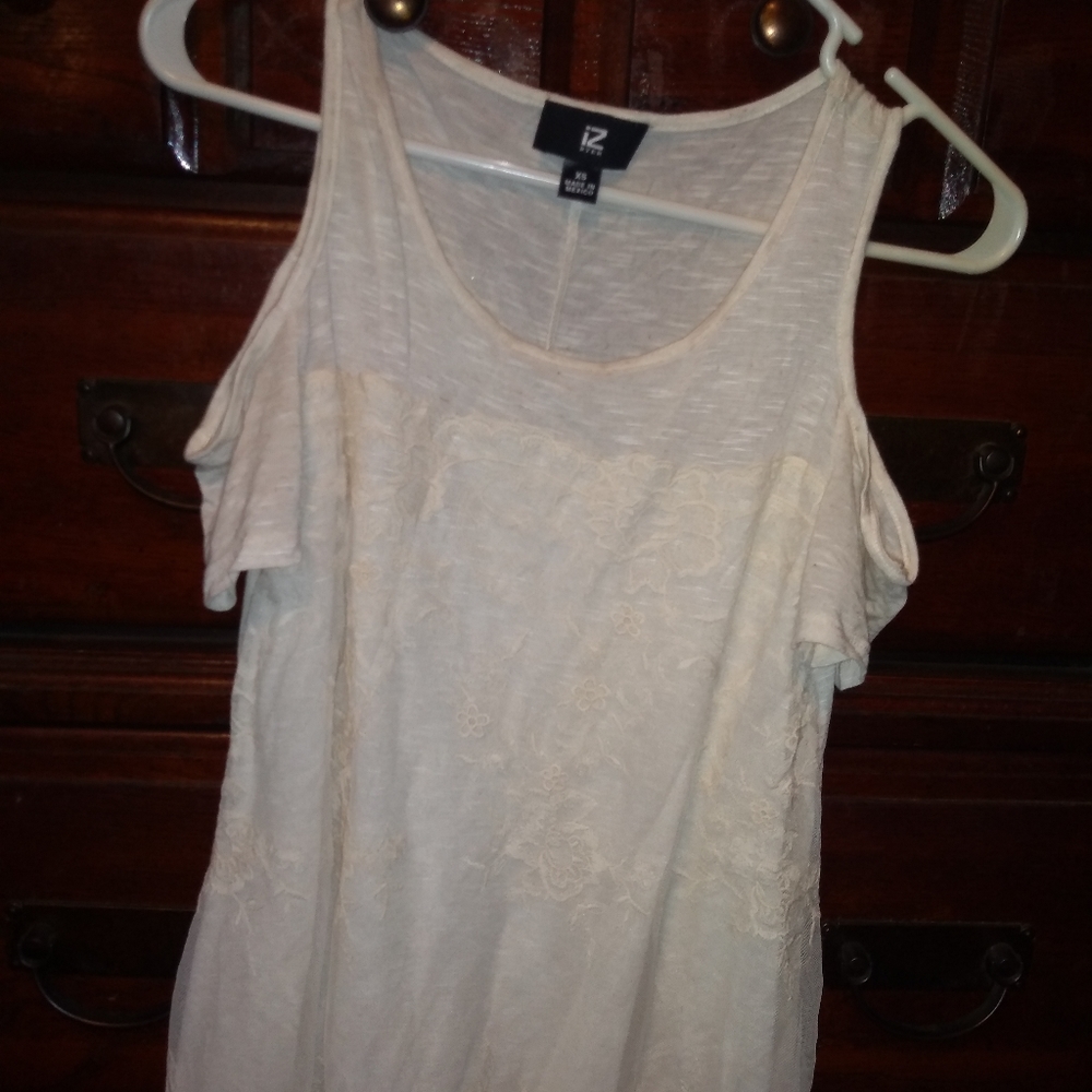 Cream cold shoulder top with lace overlay.